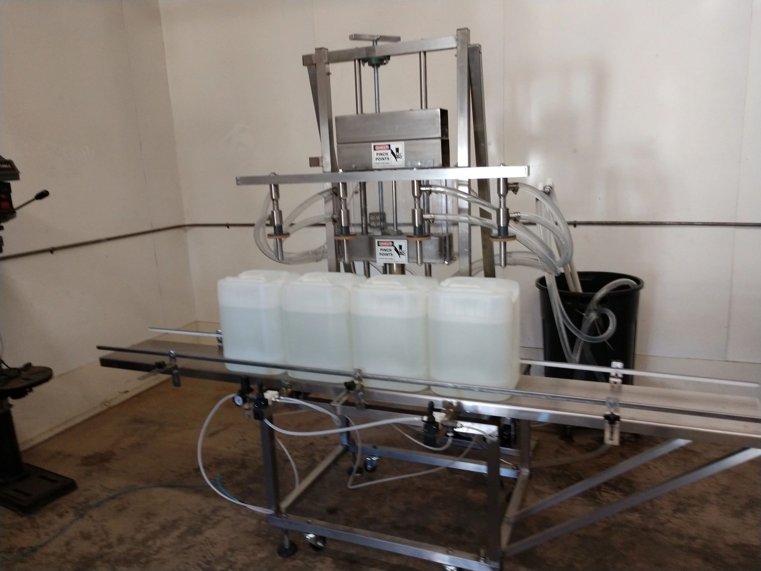 Pail filling machine filling containers in a production facility